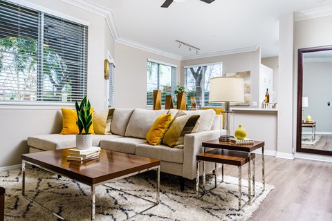 a living room with a couch and two tables